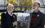 Michael, left, and Robert Meeropol, the sons of Ethel Rosenberg, pose next to an old photograph of them, before they attempt to deliver a letter to President Barack Obama in an effort to obtain an exoneration for their mother, in front of the White House, Thursday, Dec. 1, 2016. (AP Photo/Alex Brandon)