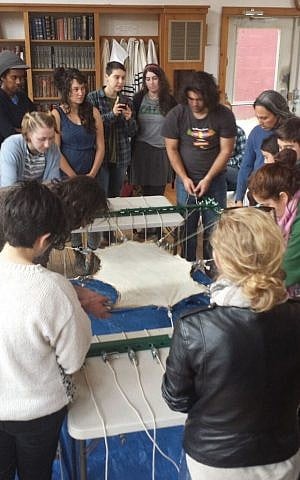 Community Torah Project members perform hide work for their Torah.(Courtesy Rabbi Linda Motzkin)