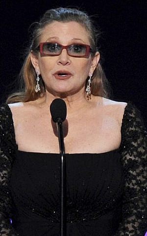 In this Sunday, Jan. 25, 2015 file photo, Carrie Fisher presents the life achievement award on stage at the 21st annual Screen Actors Guild Awards at the Shrine Auditorium in Los Angeles. (Photo by Vince Bucci/Invision/AP)