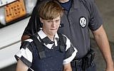 Charleston, S.C., shooting suspect Dylann Storm Roof is escorted from the Cleveland County Courthouse in Shelby, N.C. June 18, 2015. (AP Photo/Chuck Burton, File)