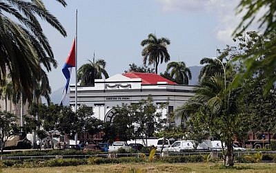 A Cuban national flag is at half-staff outside the Santa Ifigenia cemetery, in Santiago, Friday, December 2, 2016, where the ashes of the late Cuban leader Fidel Castro will be laid to rest. (AP Photo/Dario Lopez-Mills)