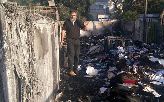 Rabbi Dov Hiyon in the fire-devastated rubble of the Haifa Conservative Synagogue (Facebook)