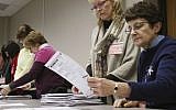 Tabulator Claudette Moll, right, from Farmington, looks over a ballot during a statewide presidential election recount Thursday, Dec. 1, 2016, West Bend, Wisconsin. (John Ehlke/West Bend Daily News via AP)