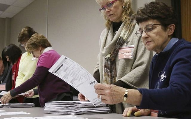 Tabulator Claudette Moll, right, from Farmington, looks over a ballot during a statewide presidential election recount Thursday, Dec. 1, 2016, West Bend, Wisconsin. (John Ehlke/West Bend Daily News via AP) Tabulator Claudette Moll, right, from Farmington, looks over a ballot during a statewide presidential election recount Thursday, Dec. 1, 2016, West Bend, Wisconsin. (John Ehlke/West Bend Daily News via AP)