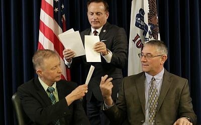 Iowa Sec. of State Paul Pate, center, collects ballots from Iowa electors Alan Braun, of Norwalk, Iowa, left, and Don Kass, of Remsen, Iowa, right, during Iowa's Electoral College vote, Monday, Dec. 19, 2016, at the Statehouse in Des Moines, Iowa. Iowa's six voters cast their ballots for Republican Donald Trump. (AP Photo/Charlie Neibergall)