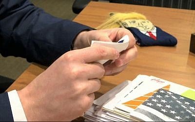 In this image from video, Electoral College elector Brian Fairbrother looks through mail he has received in Shelby Township, Mich., on Tuesday, Dec. 13, 2016.  (AP Photo/Mike Householder)