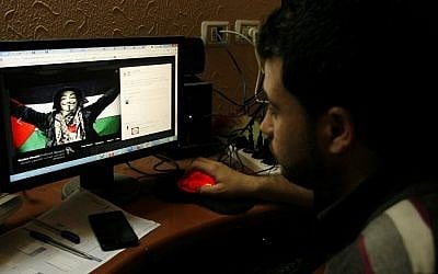 Illustrative photo of a Palestinian man looking at an anti-Israel Facebook page. April 07, 2013. (Abed Rahim Khatib/Flash90) Illustrative photo of a Palestinian man looking at an anti-Israel Facebook page. April 07, 2013. (Abed Rahim Khatib/Flash90)