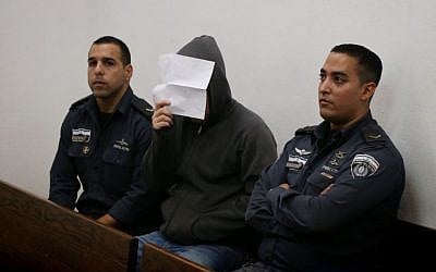 A parent suspected of child abuse sits at Tel Aviv Magistrate's Court on November 4, 2013. (Roni Schutzer/FLASH90)