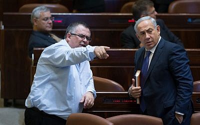 Prime Minister Benjamin Netanyahu speaks with MK David Bitan in the Knesset plenum, November 18, 2015 (Yonatan Sindel/Flash90)