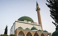 Locals gather outside of the Jazar Mosque in the Old City of the northern Israeli city of Acre on the coast of the Mediterranean Sea, June 3, 2016. (Zack Wajsgras/Flash90)
