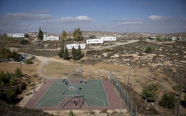 Children play soccer near trailer homes at the unauthorized Israeli outpost of Amona, in the West Bank, on November 17, 2016. (Miriam Alster/Flash90) Children play soccer near trailer homes at the unauthorized Israeli outpost of Amona, in the West Bank, on November 17, 2016. (Miriam Alster/Flash90)