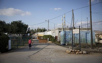 Jewish residents of the unauthorized Israeli outpost of Amona, in the West Bank, seen walking on the streets of the outpost on November 17, 2016. (Miriam Alster/Flash90)