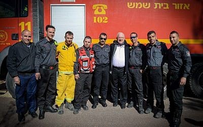 Israeli president Reuven Rivlin meets with firefighters in Nataf, outside of Jerusalem, which was damaged in a major fire in November 2016. (Mark Neyman/GPO)