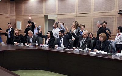 Israeli parliament members vote during a Constitution, Law, and Justice, Committee meeting regarding the so-called Regulation Bill, which is designed to avert the court-ordered demolition of the West Bank outpost of Amona, in the Knesset on November 30, 2016. (Isaac Harari/Flash90)