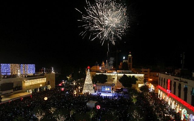 Fireworks explode during a Christmas tree lighting ceremony outside the Church of the Nativity in the West Bank town of Bethlehem on December 03, 2016. (Wisam Hashlamoun/Flash90)