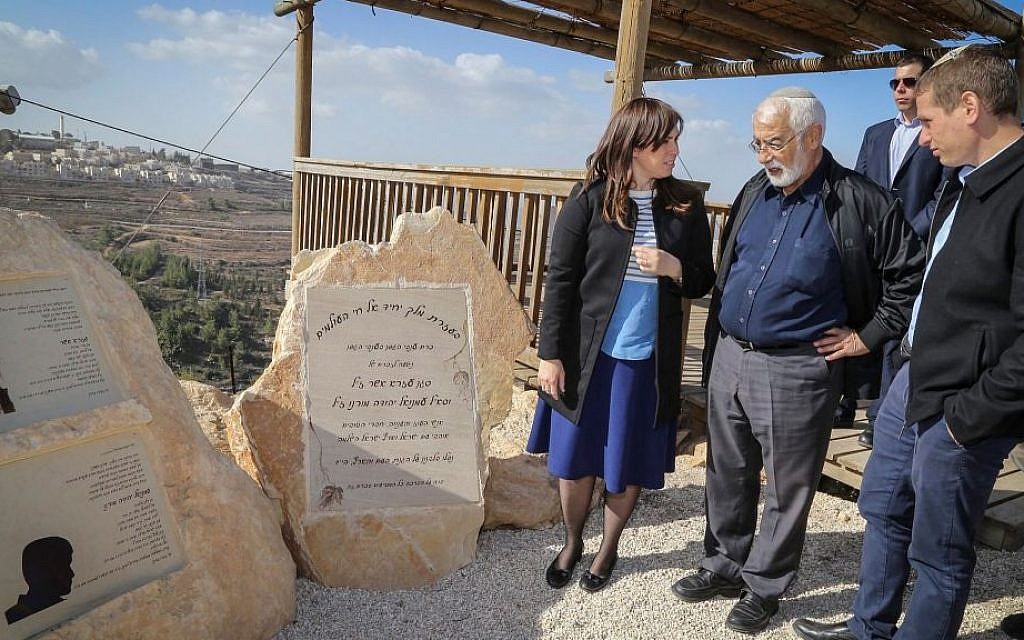 Deputy Foreign Minister Tzipi Hotovely seen with the father and brother of Emmanuel Moreno stands by his memorial monument at the Netiv Ha'avot outpost in Gush Etzion, on December 6, 2016. (Gershon Elinson/Flash90)