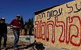 Jewish youth prepare places for people to sleep in as they plan to resist the evacuation of Amona in the West Bank, on December 9, 2016. The writing on the structure reads "there will be a war for Amona." (Tomer Neuberg/Flash90)