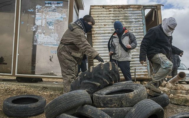 Activists prepare to resist the evacuation of Amona in the West Bank, on December 15, 2016. (Yonatan Sindel/Flash90) Activists prepare to resist the evacuation of Amona in the West Bank, on December 15, 2016. (Yonatan Sindel/Flash90)
