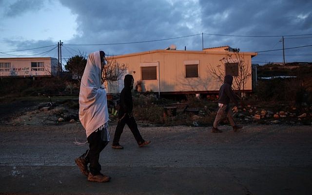 A man in a prayer shawl walks in the outpost of Amona on December 18, 2016. (Miriam Alster/Flash90) A man in a prayer shawl walks in the outpost of Amona on December 18, 2016. (Miriam Alster/Flash90)