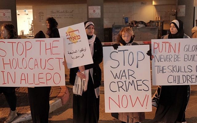 Protesters hold signs during a protest international community’s failure to stop the reported massacres of civilians trapped in the besieged Syrian city of Aleppo near the Russian embassy in Tel Aviv on December 18, 2016. (Tomer Neuberg/Flash90) Protesters hold signs during a protest international community’s failure to stop the reported massacres of civilians trapped in the besieged Syrian city of Aleppo near the Russian embassy in Tel Aviv on December 18, 2016. (Tomer Neuberg/Flash90)