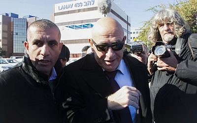 Joint (Arab) List member MK Basel Ghattas, center, arrives at the police Lahav 433 investigation unit in Lod, December 20, 2016. (Roy Alima/Flash90)