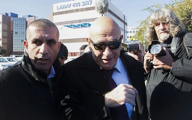 Joint (Arab) List member MK Basel Ghattas, center, arrives at the police Lahav 433 investigation unit in Lod, December 20, 2016. (Roy Alima/Flash90) 