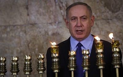 Prime Minister Benjamin Netanyahu lights Hanukkah candles at the Western Wall in Jerusalem's Old City on December 25, 2016. (Marc Israel Sellem/POOL)