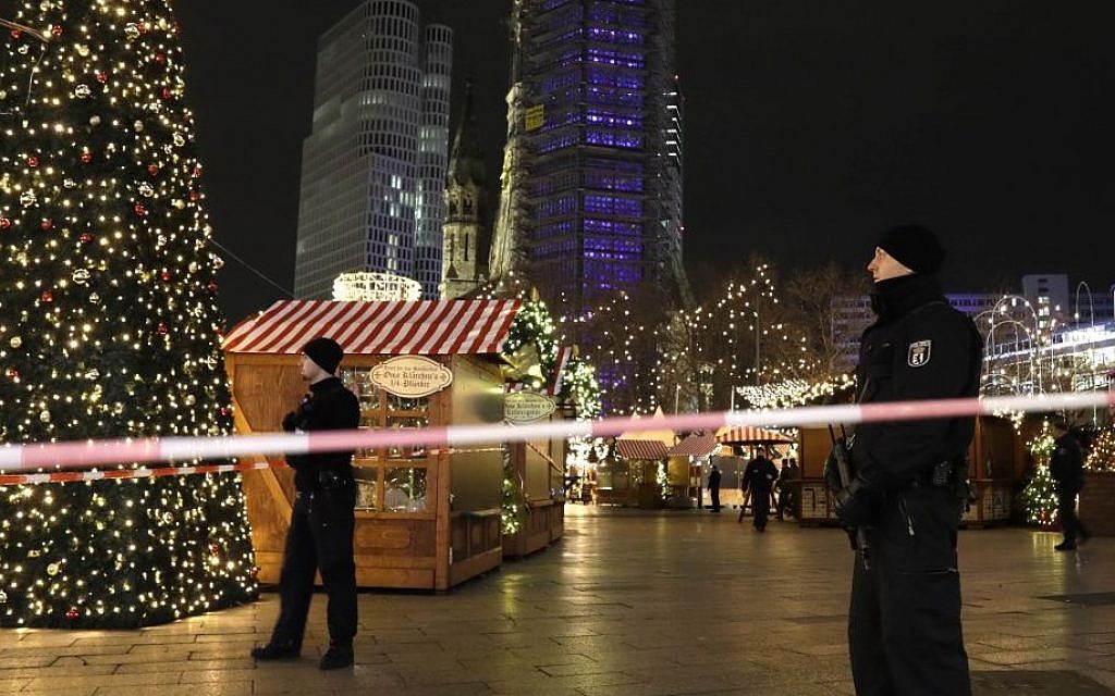 Police guard a Christmas market after a truck ran into the crowded Christmas market in Berliin Berlin, Germany, Monday, Dec. 19, 2016. (AP Photo/Michael Sohn)