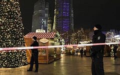 Police guard a Christmas market after a truck ran into the crowded Christmas market in Berliin Berlin, Germany, Monday, Dec. 19, 2016. (AP Photo/Michael Sohn)