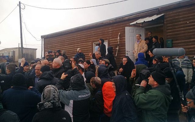 Construction Minister Yoav Galant leaving Amona surrounded by protesters who have gathered in the West Bank outpost in the hope of preventing the court-imposed evacuation, December 18, 2016. (Judah Ari Gross/Times of Israel)