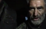 An Iranian homeless man who lives in a grave speaking with an Iranian newspaper. (Screen capture: Twitter)