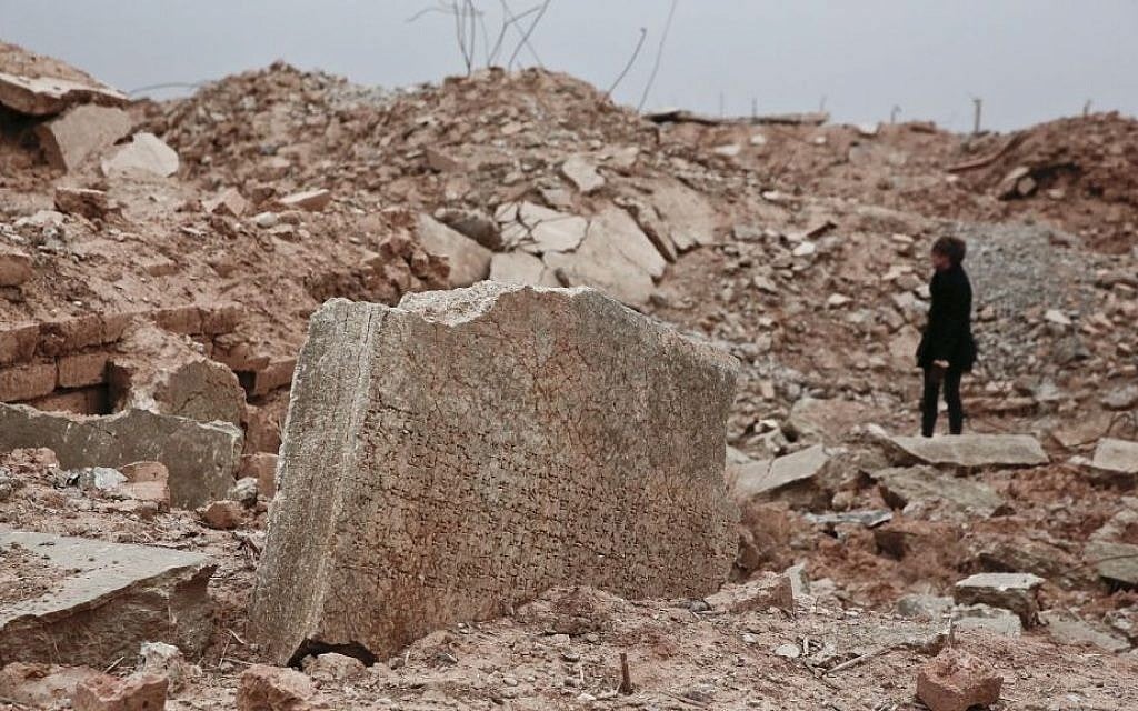 A stone tablet with cuneiform writing is seen in the foreground as UNESCO's Iraq representative Louise Haxthausen documents the damage wreaked by the Islamic State group at the ancient site of Nimrud, Iraq in this December 14, 2016, photo. (AP Photo/Maya Alleruzzo) A stone tablet with cuneiform writing is seen in the foreground as UNESCO's Iraq representative Louise Haxthausen documents the damage wreaked by the Islamic State group at the ancient site of Nimrud, Iraq in this December 14, 2016, photo. (AP Photo/Maya Alleruzzo)