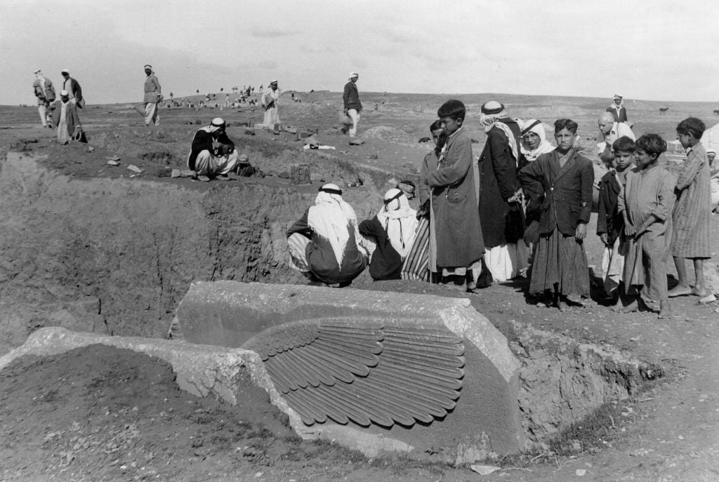 People gather around the partially-unearthed statue of a lamassu, a great winged bull protective deity, in this undated photo taken by British mystery writer Agatha Christie at the ancient site of Nimrud in northern Iraq. The lamassus at the palace gates were among the works destroyed by IS militants in 2015. Christie’s grandson, Matthew Prichard, says she would be heartbroken by the destruction, saying if she and her husband Max Malloran, were alive to see it, “they would not have recognized the places where they had been and lived and worked.” (Agatha Christie via AP) People gather around the partially-unearthed statue of a lamassu, a great winged bull protective deity, in this undated photo taken by British mystery writer Agatha Christie at the ancient site of Nimrud in northern Iraq. The lamassus at the palace gates were among the works destroyed by IS militants in 2015. Christie’s grandson, Matthew Prichard, says she would be heartbroken by the destruction, saying if she and her husband Max Malloran, were alive to see it, “they would not have recognized the places where they had been and lived and worked.” (Agatha Christie via AP)