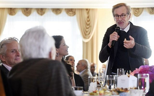 Director Steven Spielberg, right, makes a tribute to actor Kirk Douglas, foreground, during Douglas' 100th birthday party at the Beverly Hills Hotel on Friday, Dec. 9. 2016, in Beverly Hills, Calif. Looking on are Douglas' son Michael, left, and his wife Catherine Zeta-Jones. (Chris Pizzello/Invision/AP)
