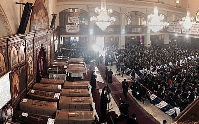 People attend a funeral service for victims of a Sunday cathedral bombing, at the Virgin Mary Church, in Cairo, Egypt, Monday, Dec. 12, 2016. (AP Photo/Nariman El-Mofty)