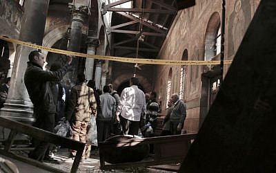 Security forces examine the scene inside St. Mark's Cathedral in central Cairo, following a bombing in which 24 were killed, Sunday, December 11, 2016. (AP Photo/Nariman El-Mofty)