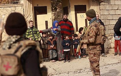 Civilians stand outside their homes as Iraq's elite counter terrorism forces regain control of their neighborhood from Islamic State militants in Mosul, Iraq, Tuesday, December 13, 2016. (AP Photo/Hadi Mizban)