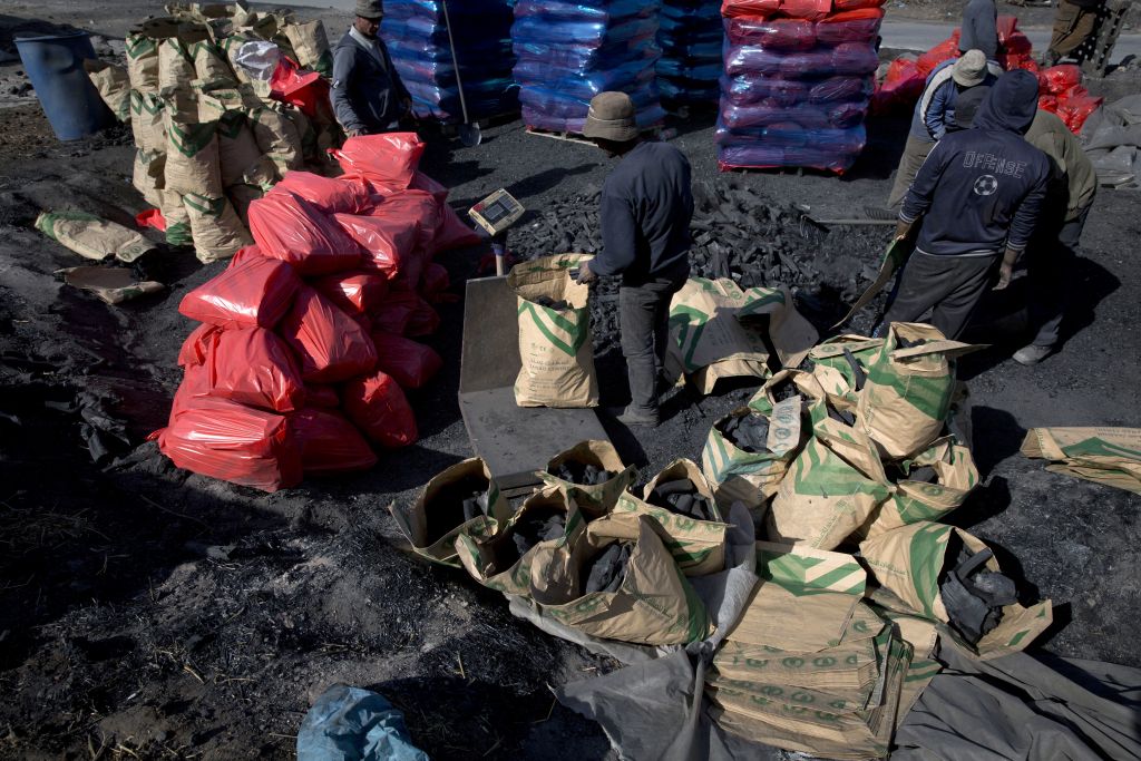 Palestinian laborers work at the site of a charcoal factory, in the West Bank town of Yabad, near Jenin. (AP Photo/Nasser Nasser) Palestinian laborers work at the site of a charcoal factory, in the West Bank town of Yabad, near Jenin. (AP Photo/Nasser Nasser)