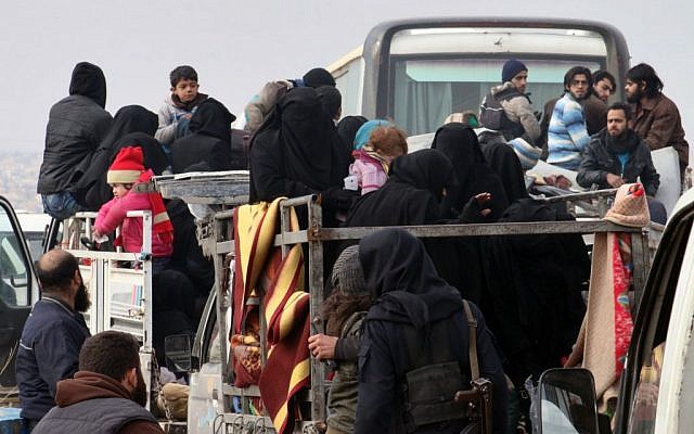 This image released by Aleppo 24, shows residents of eastern Aleppo arriving in western rural Aleppo, Syria, Friday, Dec. 16, 2016, as part of an evacuation deal. (Aleppo 24 via AP)