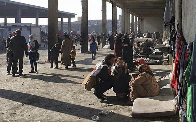 Photo released by the International Committee for the Red Cross (ICRC) shows Syrians who were displaced with their families from eastern Aleppo gathering at a collective shelter, in the village of Jibreen south of Aleppo, Syria, December. 12, 2016. (ICRC via AP) Photo released by the International Committee for the Red Cross (ICRC) shows Syrians who were displaced with their families from eastern Aleppo gathering at a collective shelter, in the village of Jibreen south of Aleppo, Syria, December. 12, 2016. (ICRC via AP)
