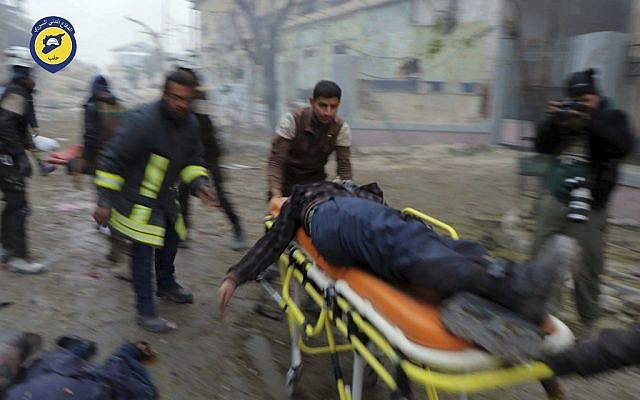 Civil Defense workers carrying a victim on a stretcher after artillery fire struck the Jub al-Quba district in Aleppo, Syria, November 30, 2016. (Syrian Civil Defense White Helmets via AP) Civil Defense workers carrying a victim on a stretcher after artillery fire struck the Jub al-Quba district in Aleppo, Syria, November 30, 2016. (Syrian Civil Defense White Helmets via AP)