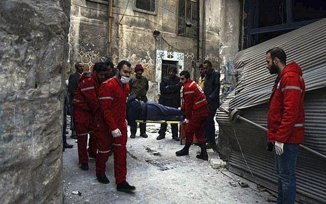 This Wednesday, Dec. 7, 2016 photo, released by the International Committee for the Red Cross, shows members of the Syrian Arab Red Crescent carrying a patient on a stretcher out of a medical facility in the Old City of Aleppo, Syria. (Syrian Arab Red Crescent/Noor Hazouri via AP) This Wednesday, Dec. 7, 2016 photo, released by the International Committee for the Red Cross, shows members of the Syrian Arab Red Crescent carrying a patient on a stretcher out of a medical facility in the Old City of Aleppo, Syria. (Syrian Arab Red Crescent/Noor Hazouri via AP)