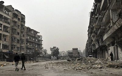 This photo released by the Syrian official news agency SANA, shows Syrian troops and pro-government gunmen marching through the streets of east Aleppo, Syria, Tuesday, Dec. 13, 2016. (SANA via AP)