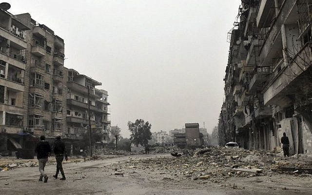 This photo released by the Syrian official news agency SANA, shows Syrian troops and pro-government gunmen marching through the streets of east Aleppo, Syria, Tuesday, Dec. 13, 2016. (SANA via AP) This photo released by the Syrian official news agency SANA, shows Syrian troops and pro-government gunmen marching through the streets of east Aleppo, Syria, Tuesday, Dec. 13, 2016. (SANA via AP)