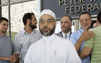 In this Thursday, Sept. 4, 2008 file photograph, Imam Mohammad Qatanani, center left, walks out of the Peter W. Rodino Jr. Federal Building in Newark, New Jersey, with supporters after an immigration judge ruled that Qatanani can remain in the United States. (AP Photo/Mike Derer, file)
