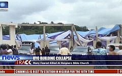 In this image taken from video people stand at the scene after the roof of The Reigners Bible Church International collapsed onto worshipers killing dozens in Uyo, southern Nigeria, December 10, 2016. (Channels TV via AP)