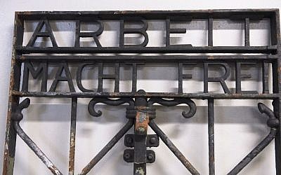 The iron gate from the former Nazi concentration camp in Dachau, southern Germany, with the slogan 'Arbeit macht frei' ('Work will set you free') is displayed Saturday Dec. 3, 2016, after being found earlier this week by police in Bergen, Norway. (Marit Hommedal/NTB scanpix via AP)