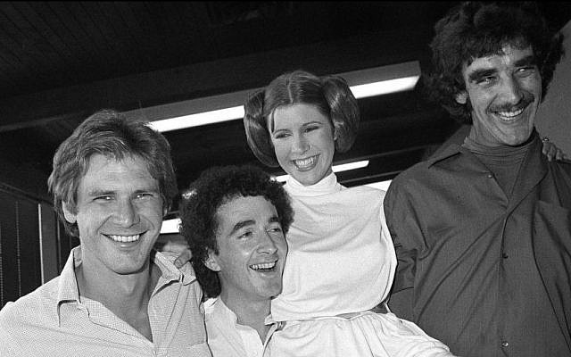 From left, Star Wars actors Harrison Ford (Han Solo), Anthony Daniels (C-3PO), Carrie Fisher (Leia Organa) and Peter Mayhew (Chewbacca) take a break from filming a television special in Los Angeles, October 5, 1978. (AP/George Brich)