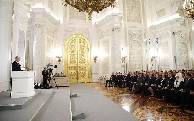 Russian President Vladimir Putin, left, gives his annual state of the nation address in the Kremlin in Moscow, Russia, December 1, 2016. (Dmitry Astakhov/ Sputnik, Government Press Service Pool photo via AP) 
