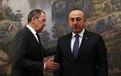 Russian Foreign Minister Sergey Lavrov, right, and Turkey's Foreign Minister Mevlut Cavusoglu attend a ceremony in memory of Russian Ambassador to Turkey Andrey Karlov, who was fatally shot by a Turkish policeman Monday at a gathering in Ankara, Turkey, before their talks on Syria in Moscow, Russia, December 20, 2016. (Maxim Shemetov/Pool Photo via AP)